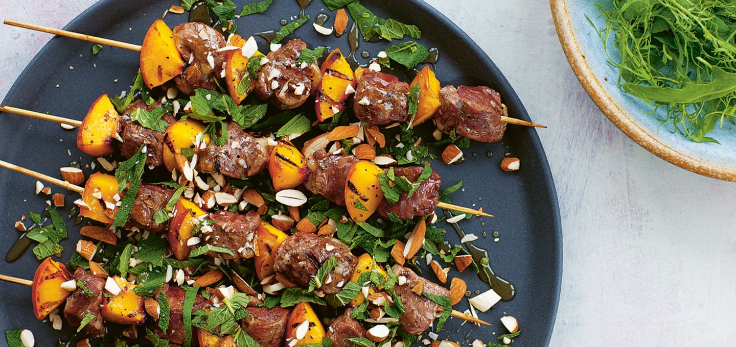 Goat kebabs with peaches, honey, almonds and mint by James Whetlor